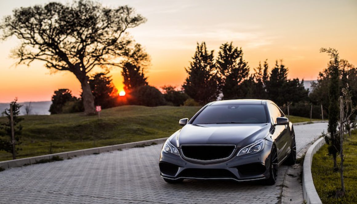 grey-luxury-sedan-car-sunset_114579-4045